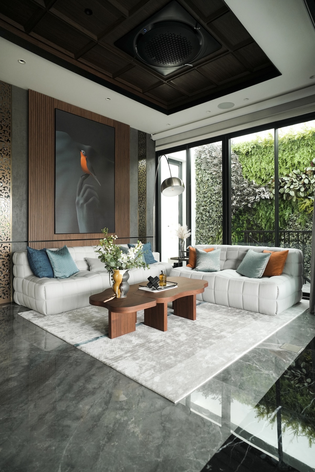 Modern living room with tufted modular seating and living green wall