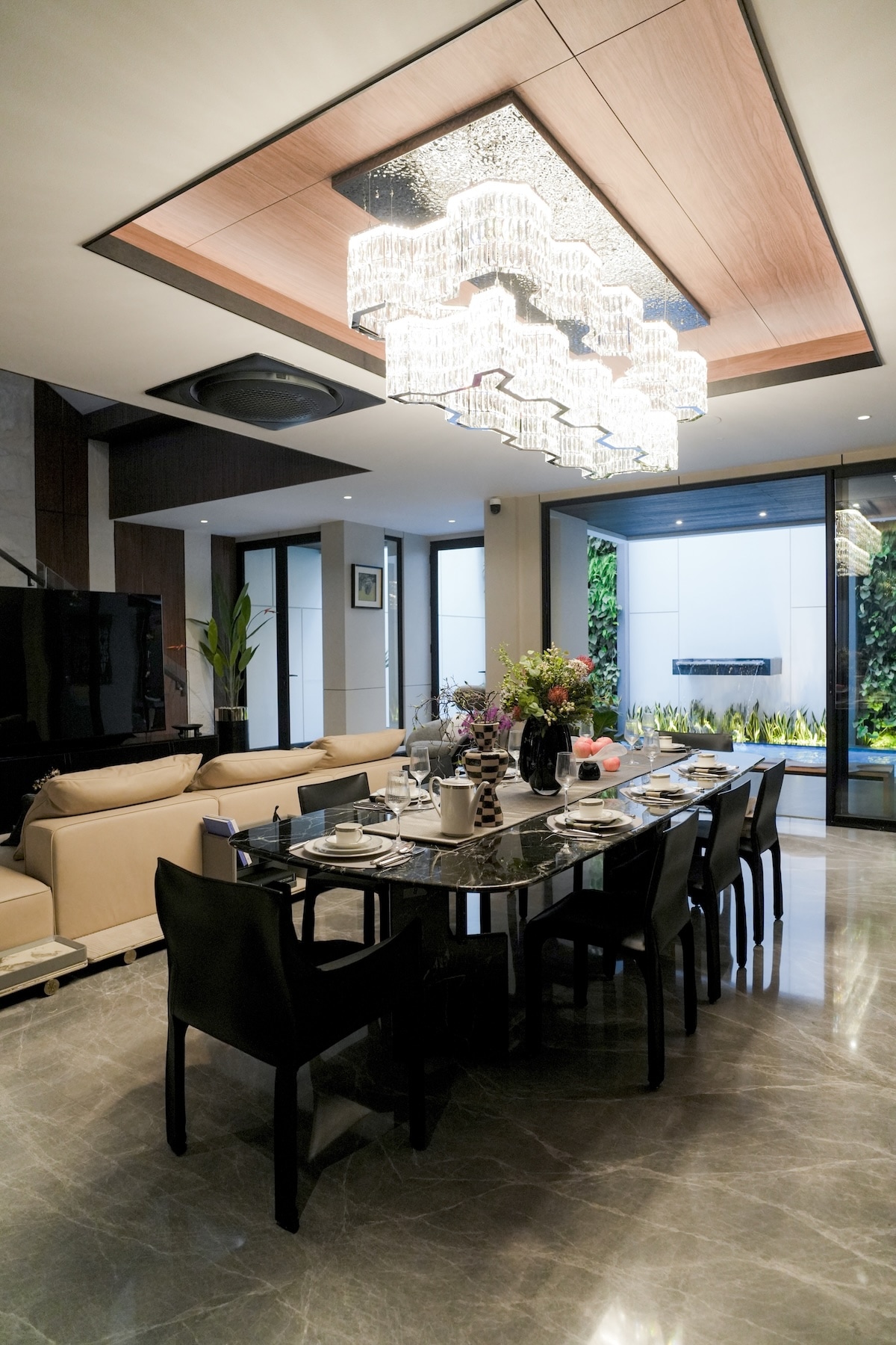 Formal dining room with black marble table and crystal chandelier