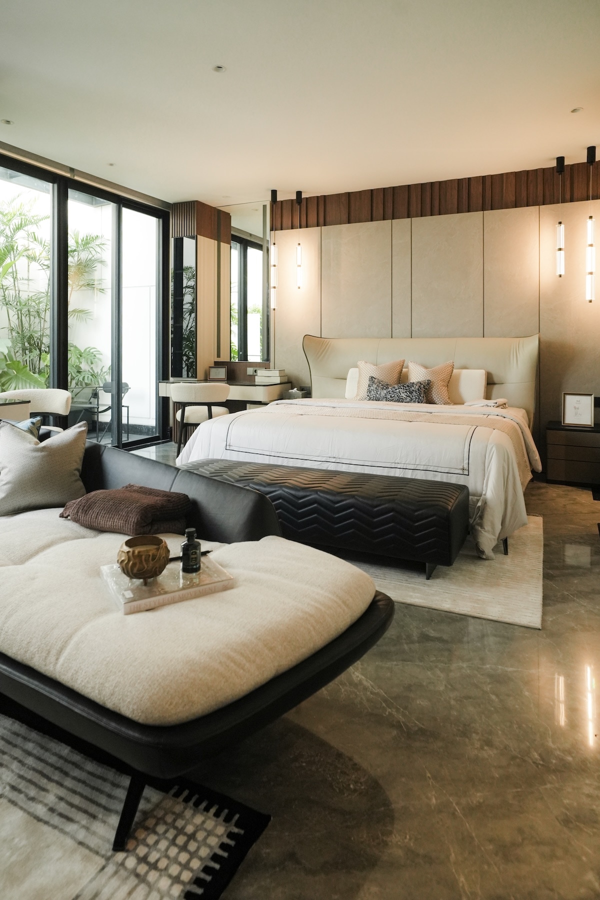 Luxury primary suite with wraparound headboard and garden views