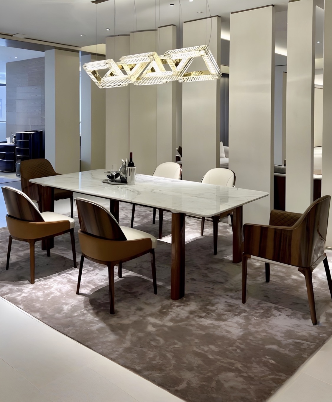 Refined dining collection with marble table and chandelier in a partner factory showroom